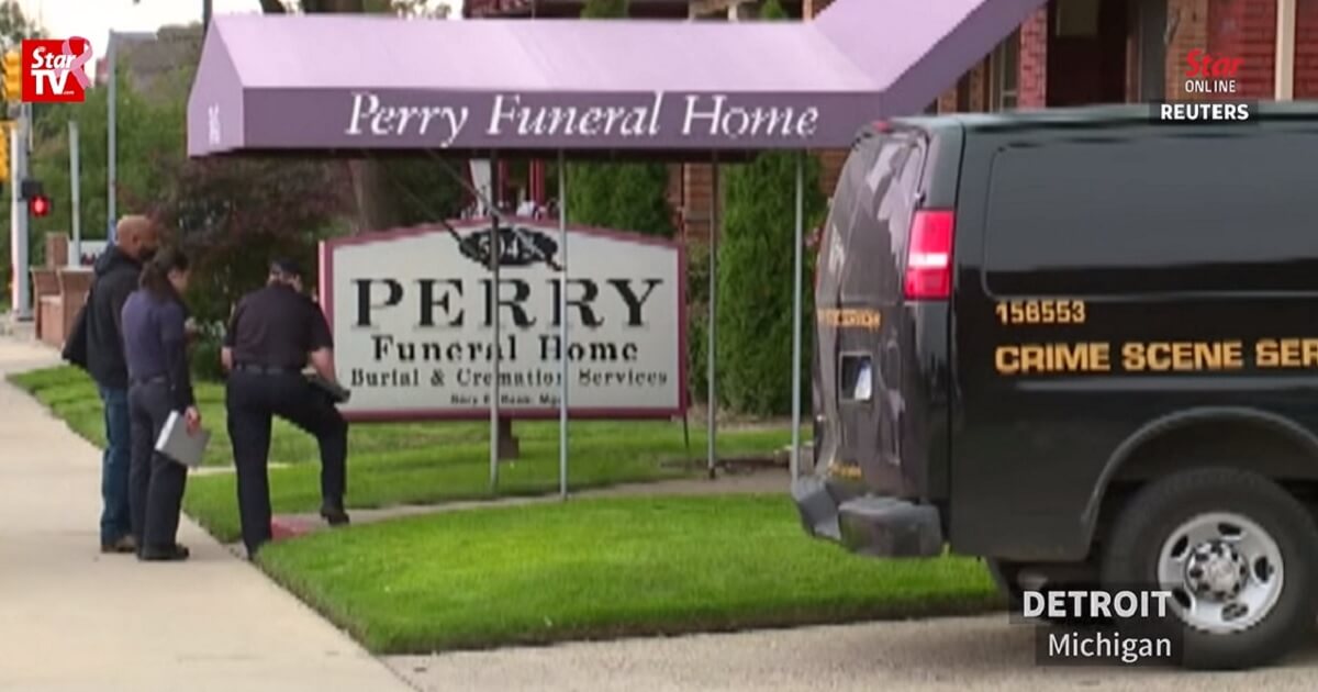 Police gather outside Perry Funeral Home in Detroit. The funeral home is the city's second where the remains of infants have been found.
