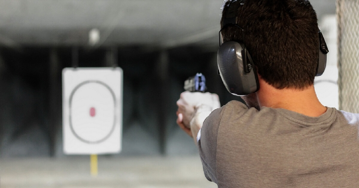 Man with handgun at shooting range.