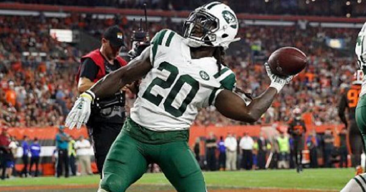 New York Jets running back Isaiah Crowell prepares to launch a football into the stands after scoring against his former team the Cleveland Browns on Sept. 23.