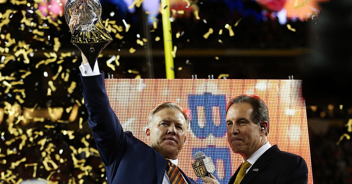 John Elway hoists the Lombardi Trophy after Denver's Super Bowl 50 victory over the Carolina Panthers.