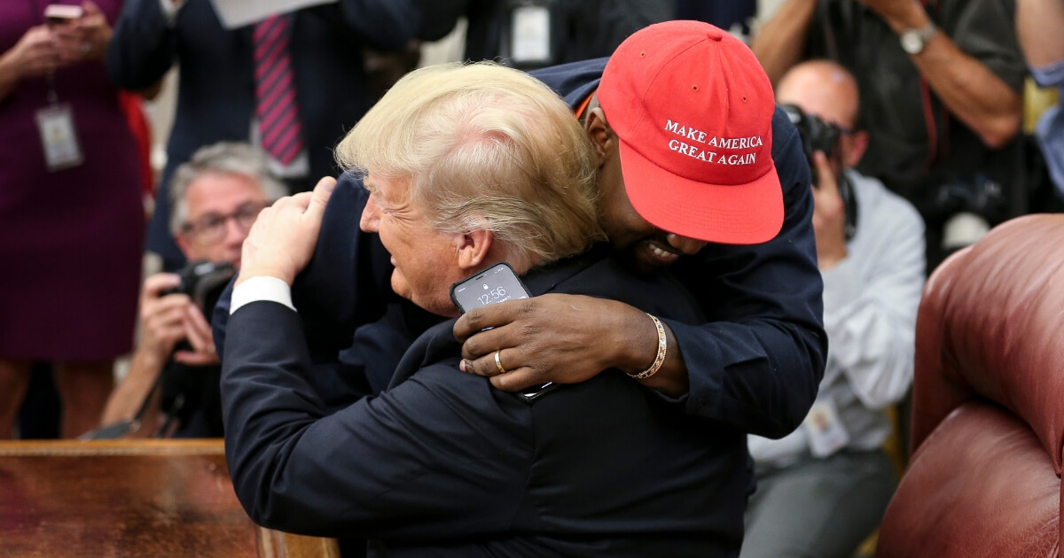 Rapper Kanye West hugs President Donald Trump during a meeting in the Oval Office of the White House on Thursday.