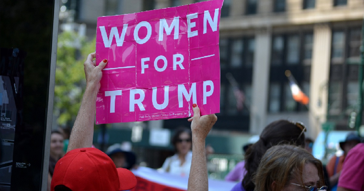 A counterdemonstrator holds a "Women for Trump" sign to show her support for the president at a rally in August in New York by demonstrators opposed to the confirmation of now-Supreme Court Justice Brett Kavanaugh.