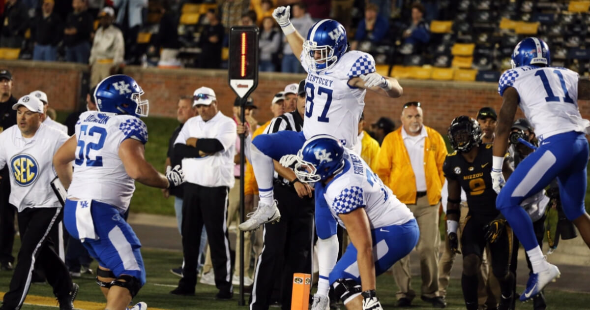 Tight end C.J. Conrad (87) celebrates with his teammates after catching the game-winning pass on the final play of Kentucky's 15-14 win at Missouri on Saturday.