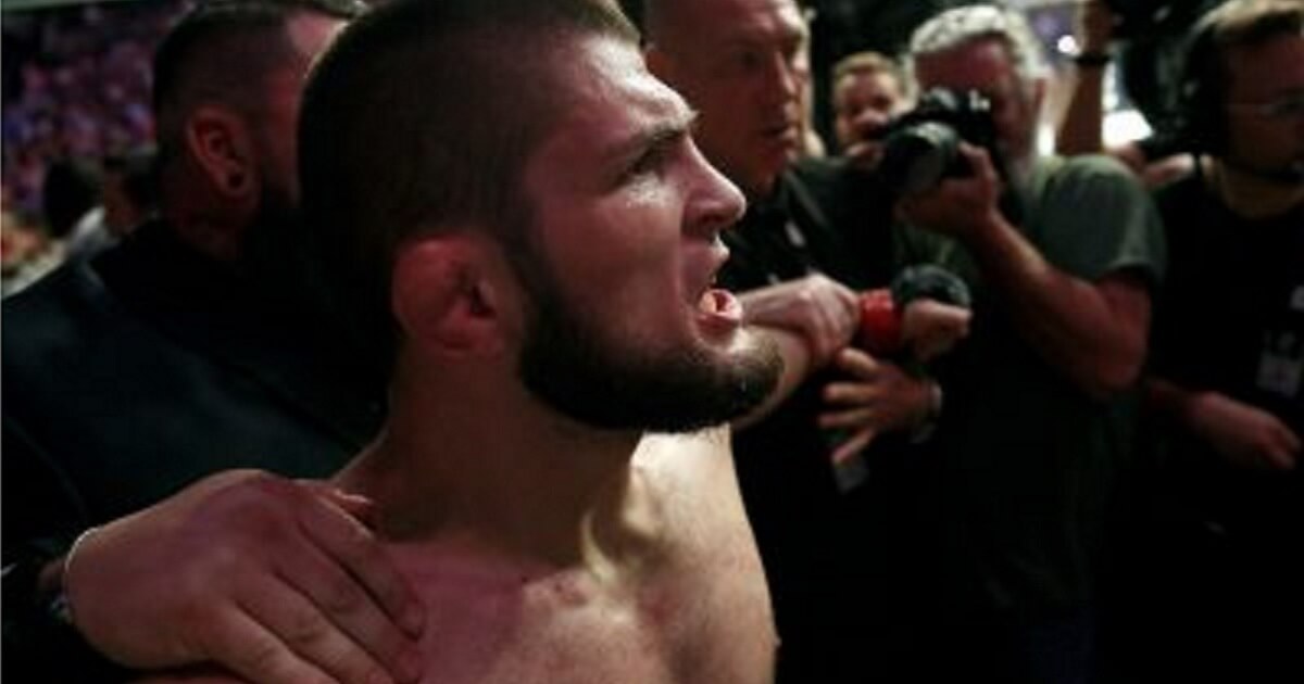 Russian UFC fighter Khabib Nurmagomedov is held back outside of the cage after beating Conor McGregor in a lightweight title mixed martial arts bout at UFC 229 in Las Vegas on Oct. 6.