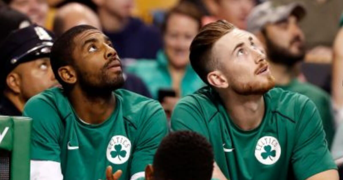 Boston Celtics Kyrie Irving, left, and Gordon Hayward look on from the bench during a 2017 game. With both players healthy, Boston is considered the presumptive favorite in the Eastern Conference.