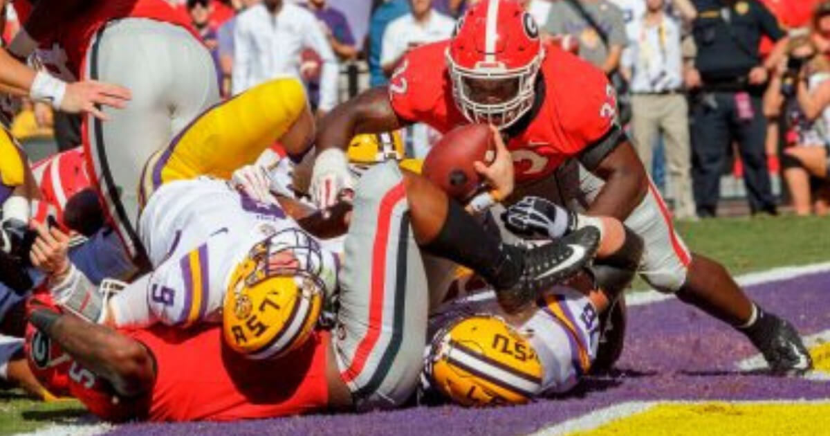 LSU quarterback Joe Burrow (9) scores a touchdown against visiting Georgia on Saturday.