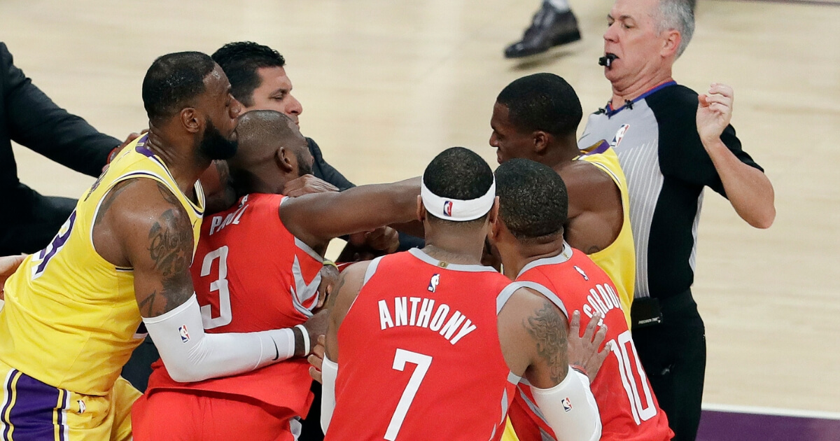 Chris Paul, second from left, is held back by LeBron James, left, as Paul fights with Lakers guard Rajon Rondo, center obscured, during the second half of Saturday's game in Los Angeles.