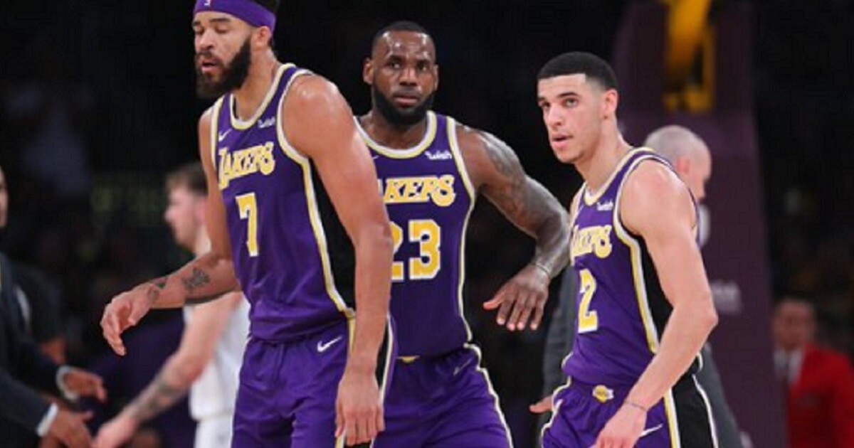 Los Angeles Laker LeBron James, center, sank a final free throw Wednesday night at the Staples Center to snatch a victory over the Dallas Mavericks.