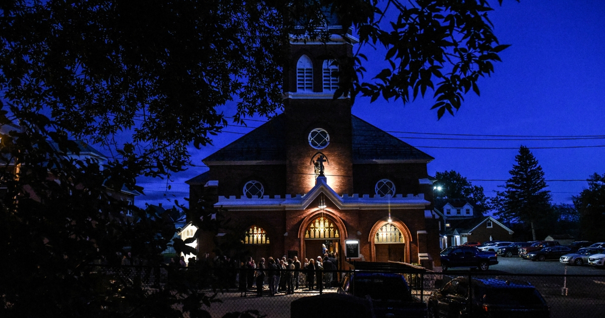 Mourners line up in front of St. Stanislaus Roman Catholic Church