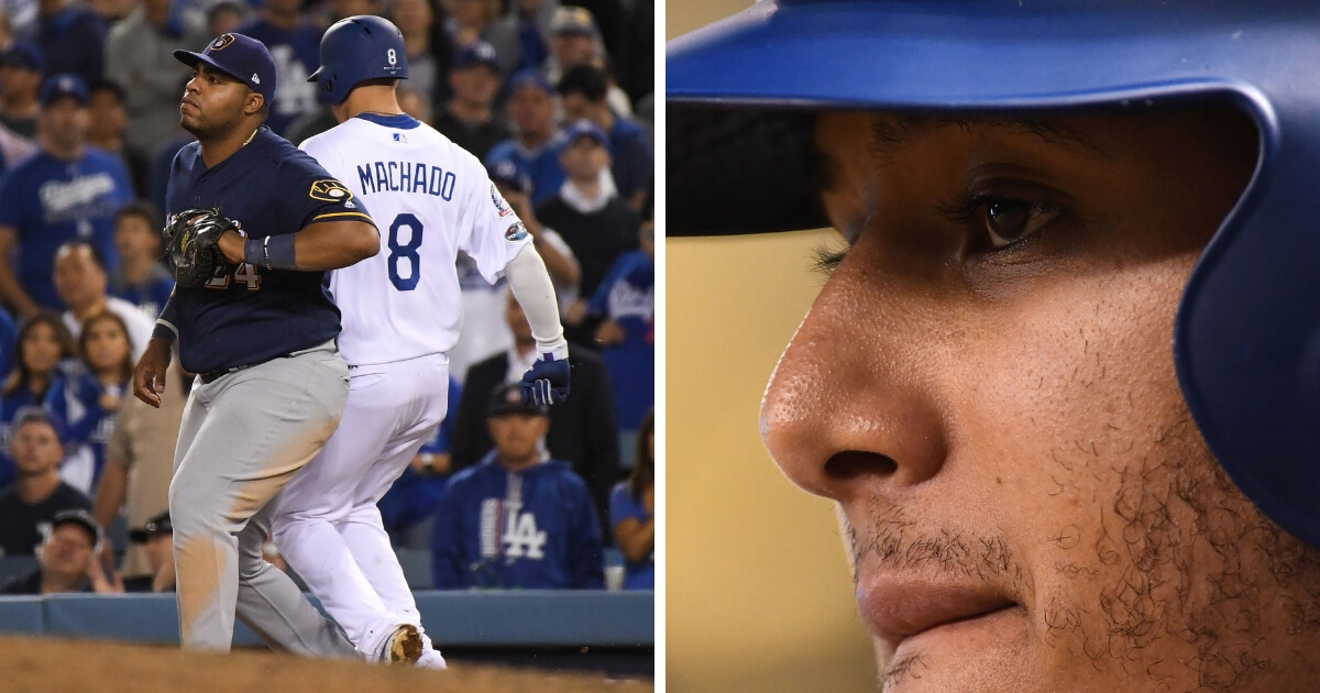 Manny Machado of the Los Angeles Dodgers kicks the leg of Milwaukee Brewers first baseman Jesus Aguilar in the 10th inning in Game 4 of the NL Championship Series at Dodger Stadium on Tuesday. MLB has now fined Machado, right, for the incident.