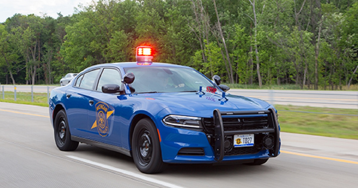 A Michigan State Police cruiser on a highway.