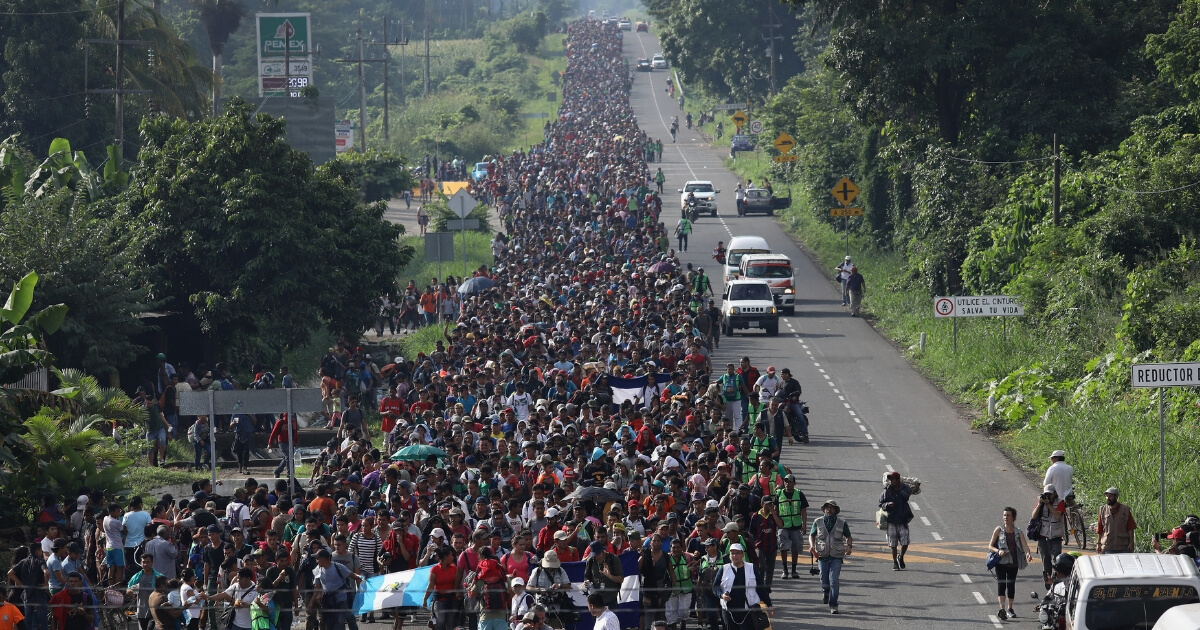 A migrant caravan, which has grown into the thousands, walks into the interior of Mexico after crossing the Guatemalan border on Oct. 21, 2018, near Ciudad Hidalgo, Mexico.