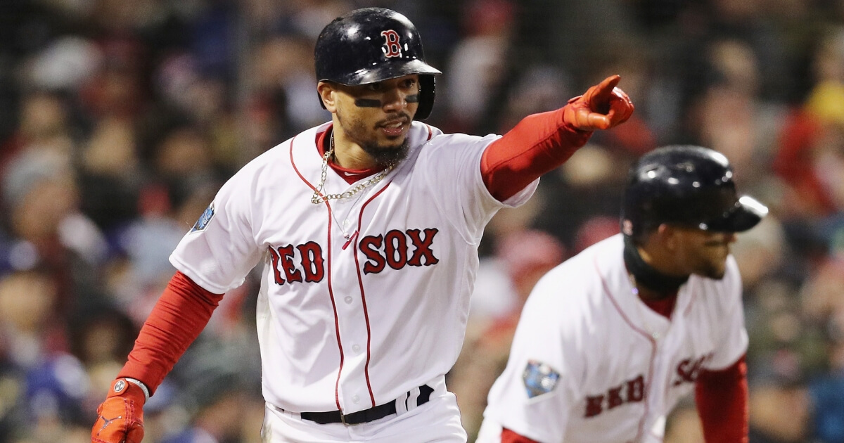 Mookie Betts of the Boston Red Sox celebrates after scoring against the Los Angeles Dodgers in Game 2 of the World Series at Fenway Park on Wednesday.