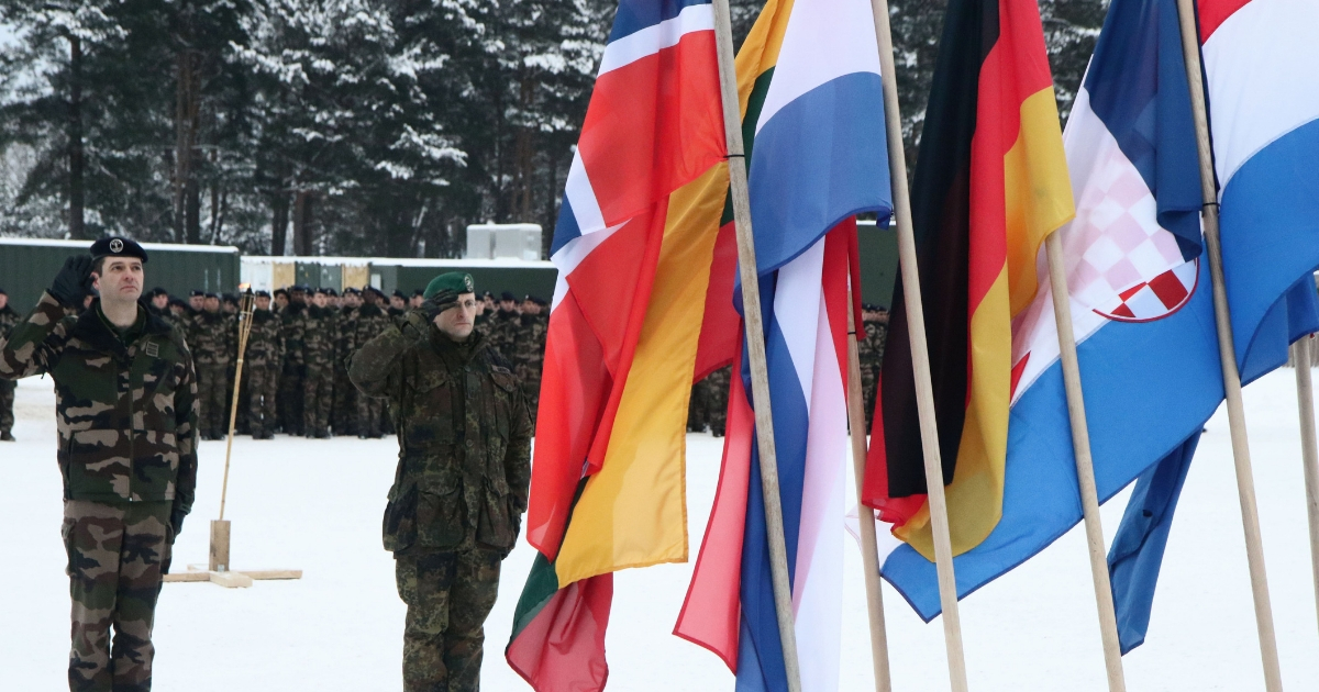 Commander of the NATO eFP battalion battlegroup and the German contingent in Lithuania, Lieutenant Colonel Thorsten Gensler (R) and Commander of the French contingent Lieutenant Colonel Martin Wencesl salute during the handing over ceremony greeting French soliders arriving for the beginning of their service with the NATO enhanced Forward Presence Battalion Battle Group in Rukla, Lithuania, on Jan. 22, 2018.