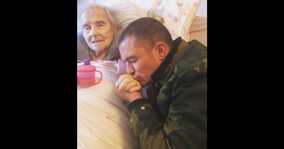 Orlando Bloom kisses his grandmother's hand.