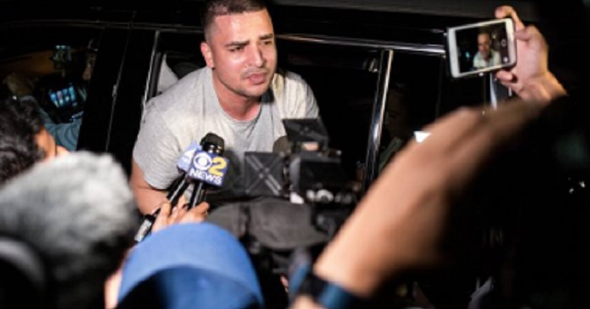 Pablo Villavicencio Calderon, an illegal immigrant, is shown surrounded by the media after his arrest at a New York City Army base while delivering a pizza in July.