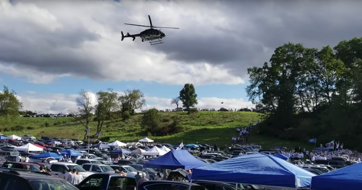A police helicopter flies over Penn State tailgaters before the Nittany Lions' game against Ohio State on Saturday.