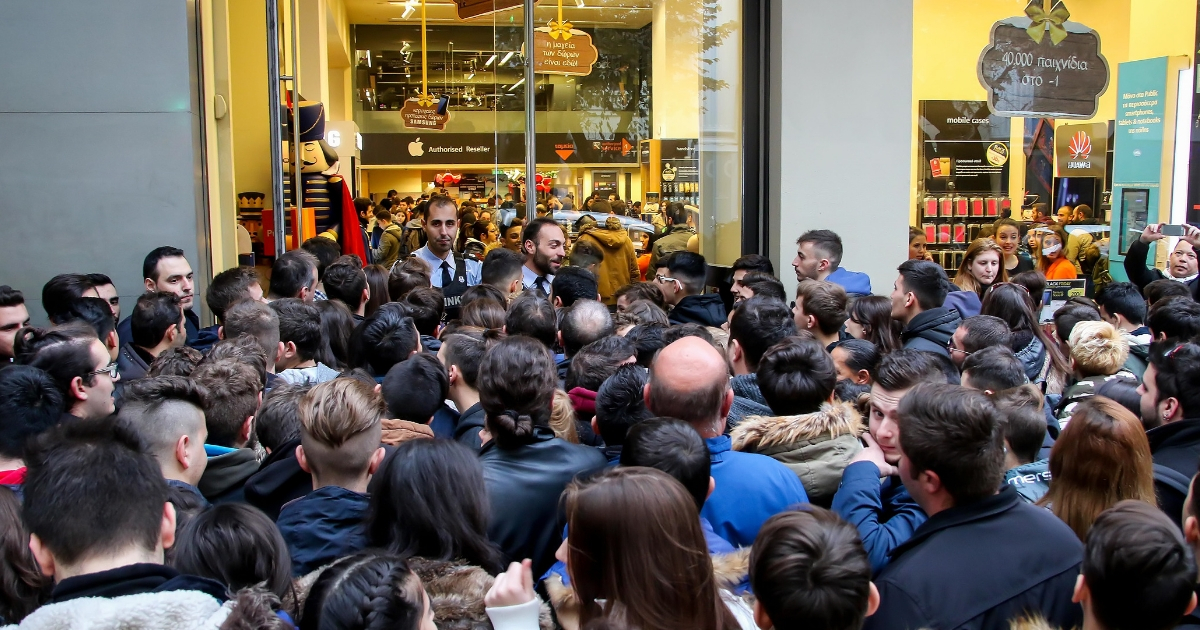 People wait outside a department store on Black Friday.