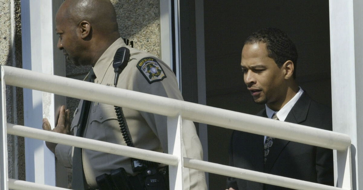 Former Carolina Panthers receiver Rae Carruth, right, walks to a 2005 court appearance in an attempt to overturn a 2001 conviction and sentence in the 1999 slaying of his pregnant girlfriend.