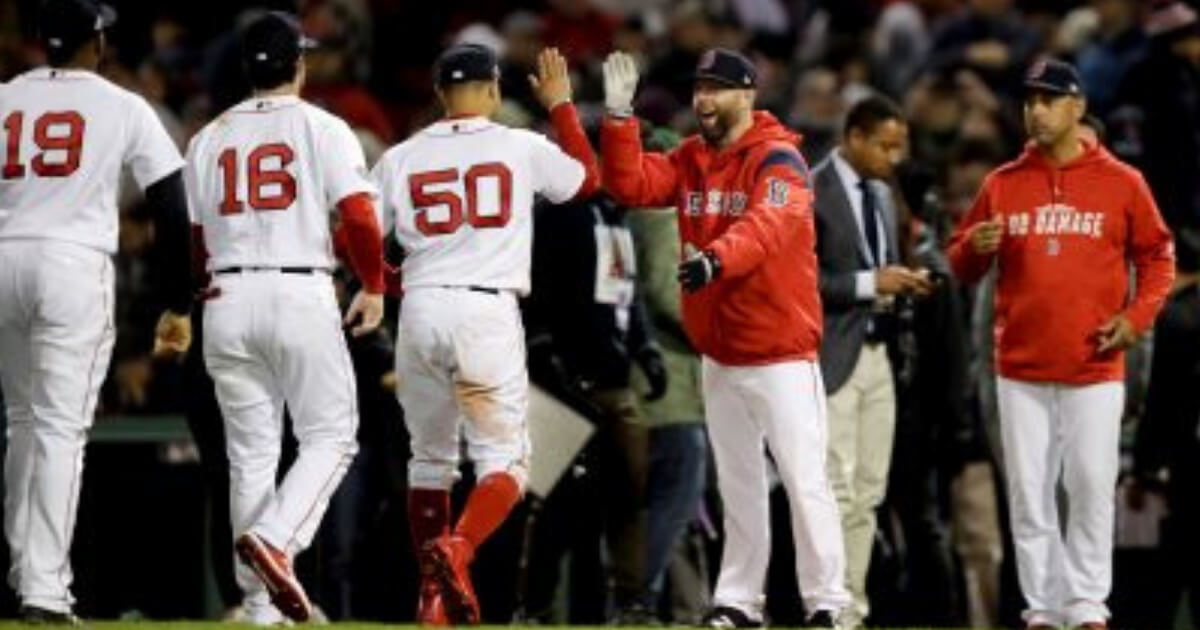 Members of the Boston Red Sox celebrate after their 7-5 win Sunday against the Houston Astros in Game 2 of the American League Championship Series in Boston.