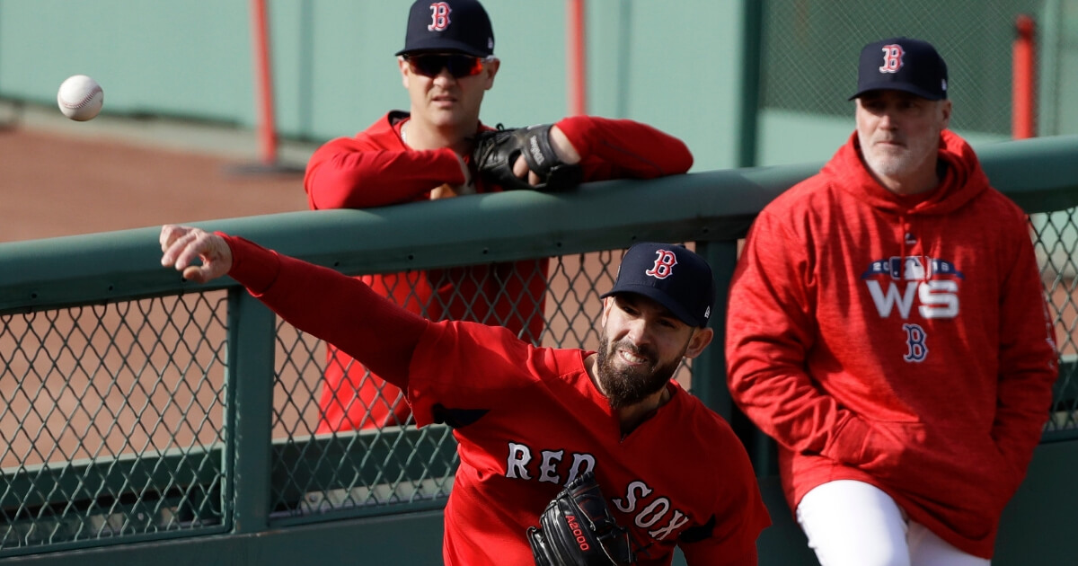 Boston Red Sox pitcher Rick Porcello, center, throws in the bullpen during a team workout Monday.