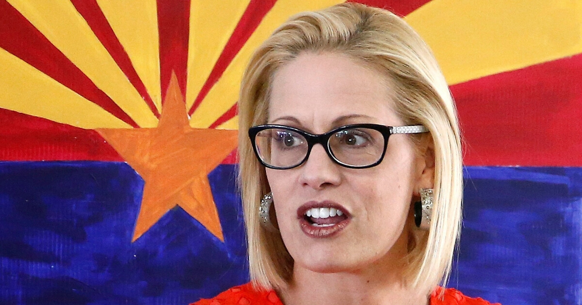 Rep. Kyrsten Sinema, D-Ariz., talks to campaign volunteers at a Democratic campaign office on primary election day in Phoenix.
