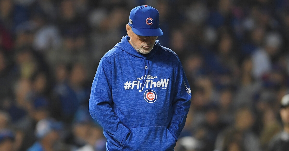 Cubs manager Joe Maddon walks to the pitcher's mound in the eighth inning of the NL wild-card game against the Colorado Rockies on Tuesday at Wrigley Field.
