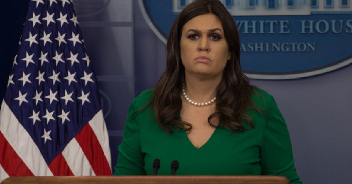 Sarah Sanders at the podium during a White House news briefing.