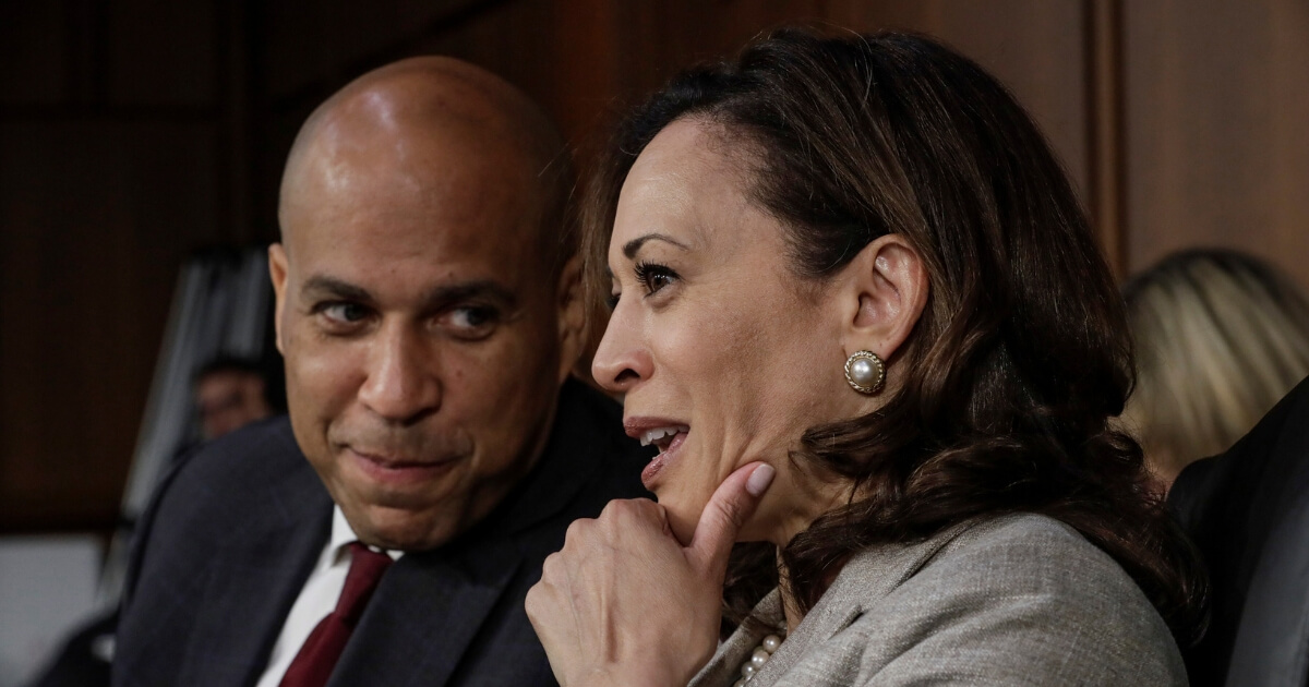 Sen. Cory Booker, D-N.J., and Sen. Kamala Harris, D-Calif., speak together on the last day of the Senate Judiciary Committee's confirmation hearing for President Donald Trump's Supreme Court nominee, Brett Kavanaugh, on Capitol Hill in Washington, Sept. 7, 2018.