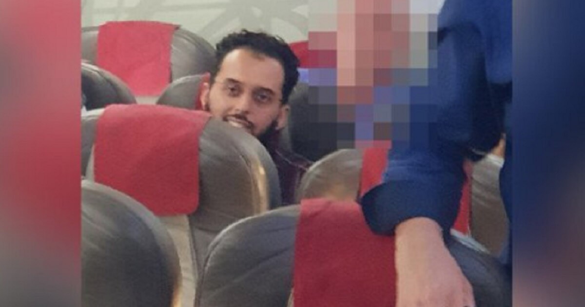 Man grins from airplane seat after being released from a German prison after serving his sentence in connection with the 9/11 attack.