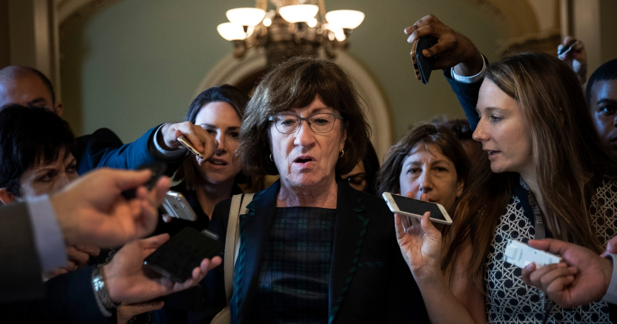 Sen. Susan Collins, R-Maine, is surrounded by reporters following a Sept. 26 meeting on Capitol Hill about the Supreme Court nomination of Brett Kavanaugh.