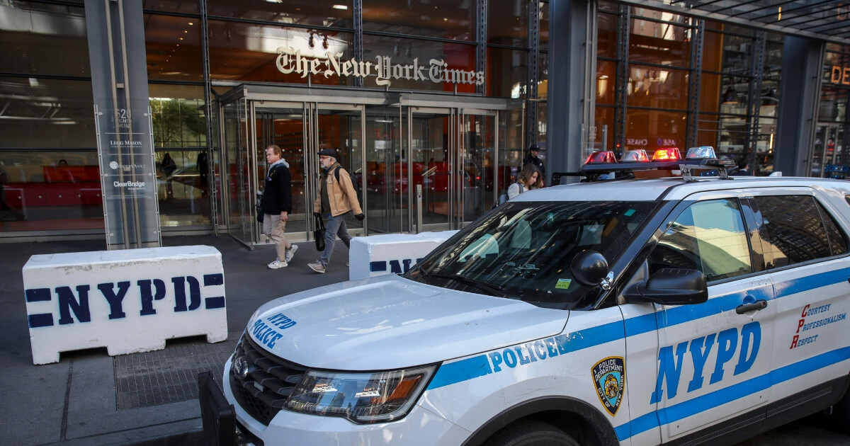 New York City Police vehicles sit parked outside the office of the The New York Times