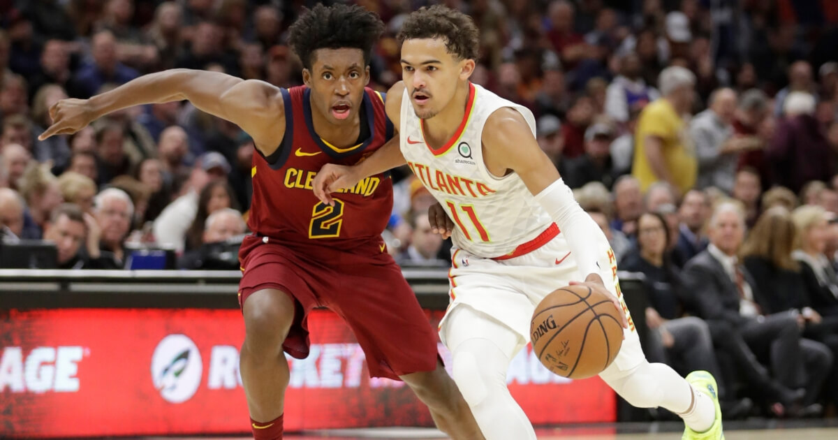 Atlanta's Trae Young (11) drives past Collin Sexton during Atlanta's 133-111 victory.