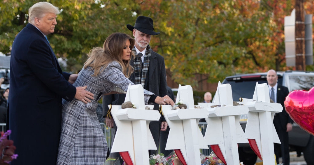 President Donald Trump and first lady Melania Trump, alongside Rabbi Jeffrey Myers, place stones and flowers on a memorial Tuesday as they pay their respects at the Tree of Life Synagogue following last weekend's shooting in Pittsburgh.