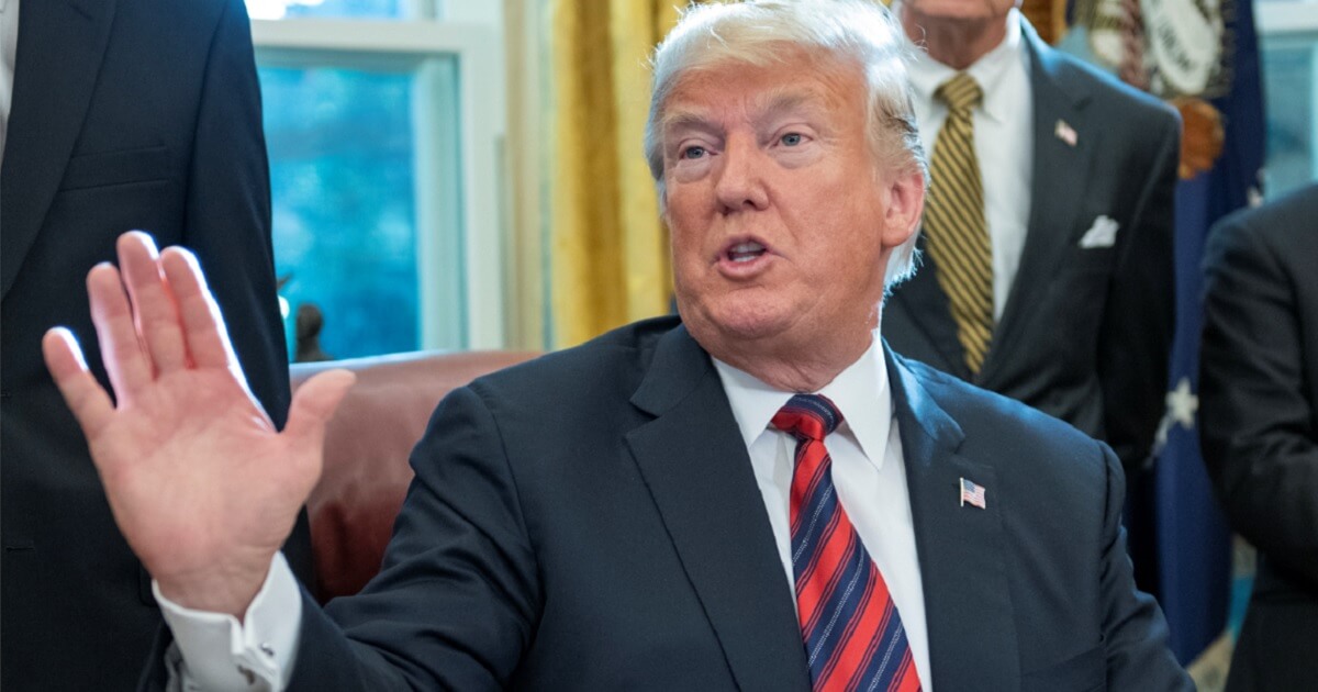 President Donald Trump gestures Tuesday while fielding question in the Oval Office.