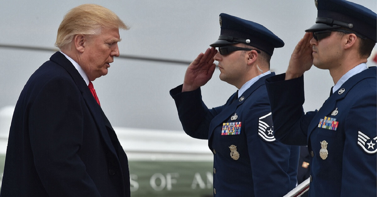 President Donald Trump is saluted as he transfers from Marine One to Air Force One at Andrews Air Force Base in Maryland in March.