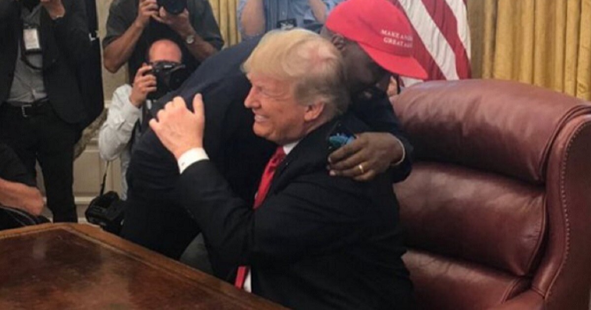 President Donald Trump embraces entertaiment star Kanye West Thursday during an Oval Office meeting.