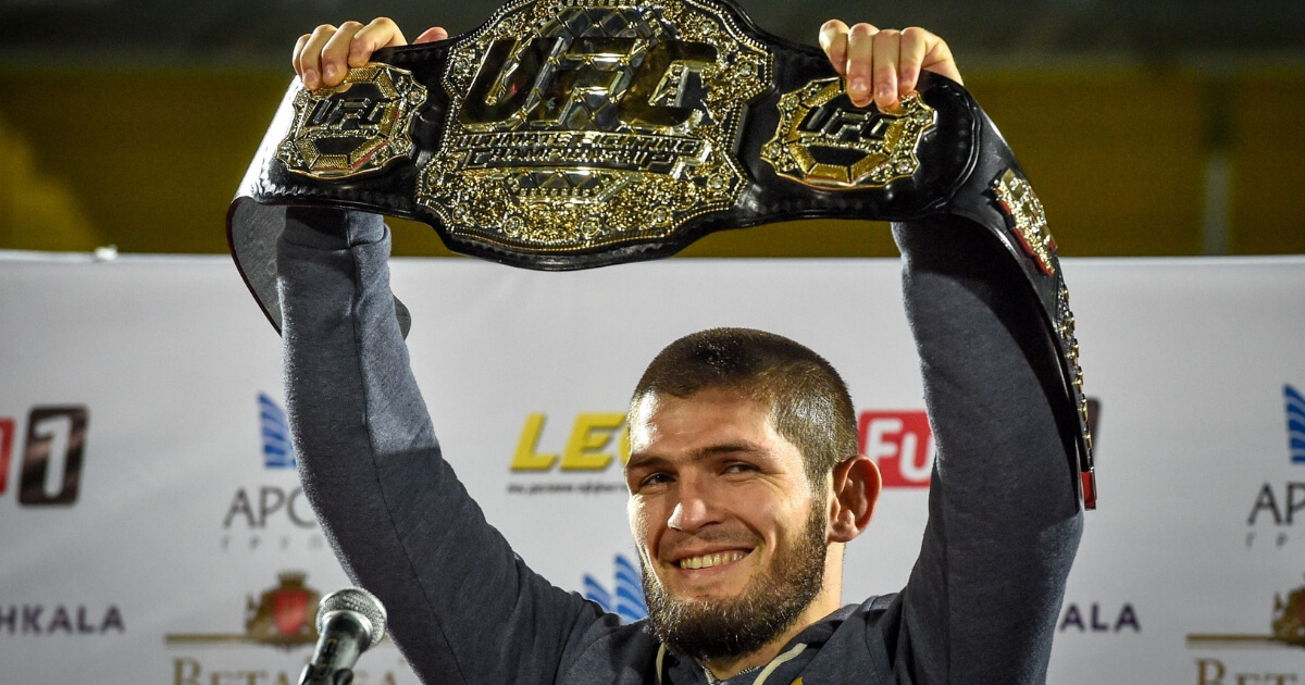 UFC lightweight champion Khabib Nurmagomedov of Russia raises his belt upon arriving in Makhachkala on Monday.