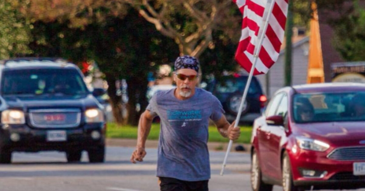 Wayne Parfitt carries an American flag with him each time he goes for a run as a salute to all military personnel, including his son.