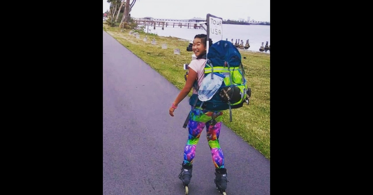 A woman on rollerblades with a backpack on.