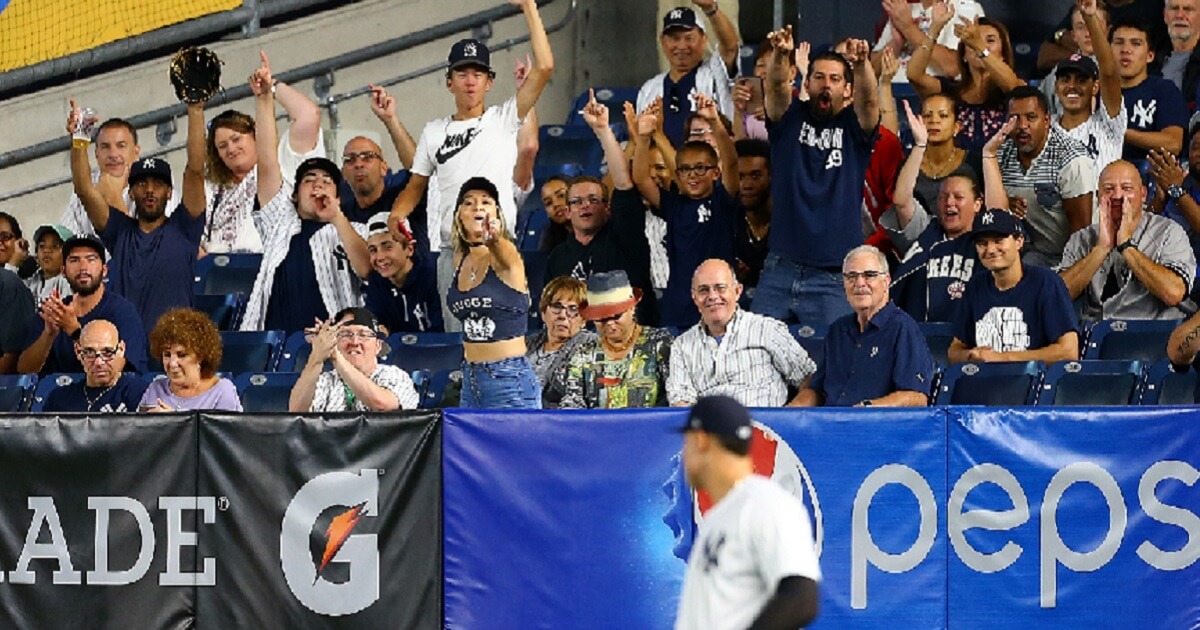 Yankees fans cheer as Aaron Judge takes the field in a September game at Yankee Stadium.