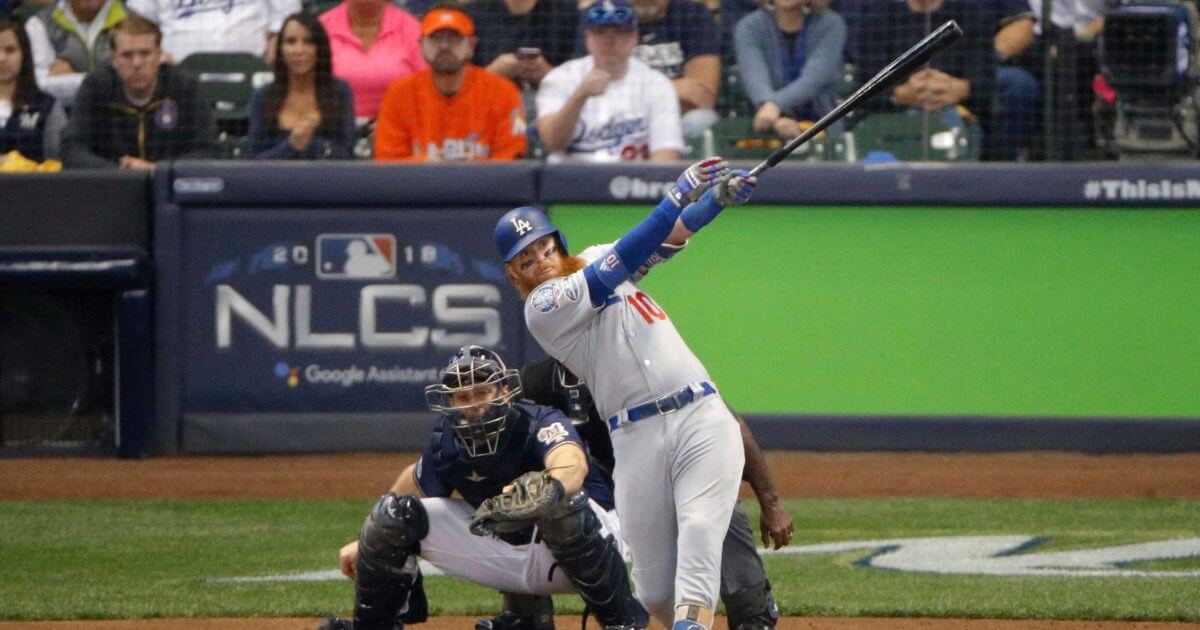 Justin Turner hits a two-run home run during the eighth inning of Game 2 of the National League Championship Series against the Brewers Saturday in Milwaukee.