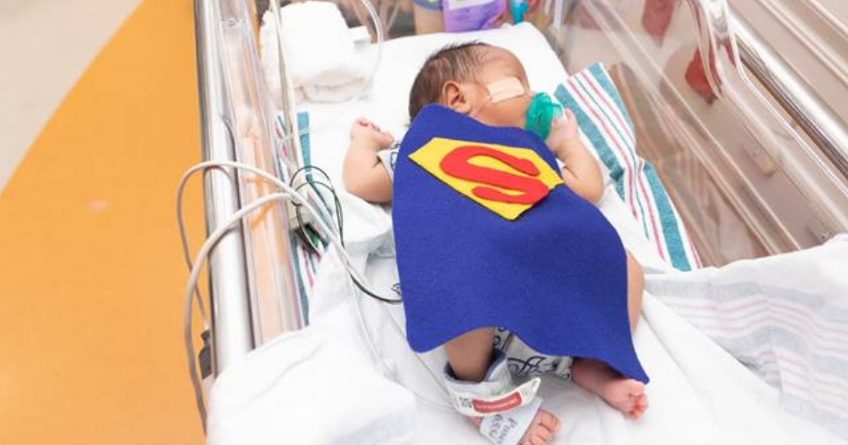 Baby in a Superman cape.