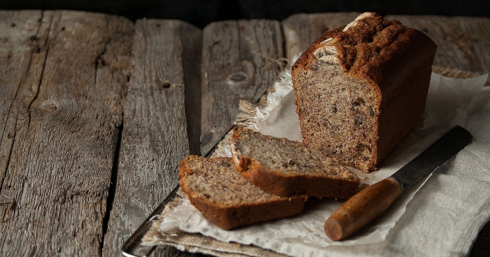 Delicious, Home baked Banana Bread, Sliced on a Cutting Board on a Wooden Kitchen Table