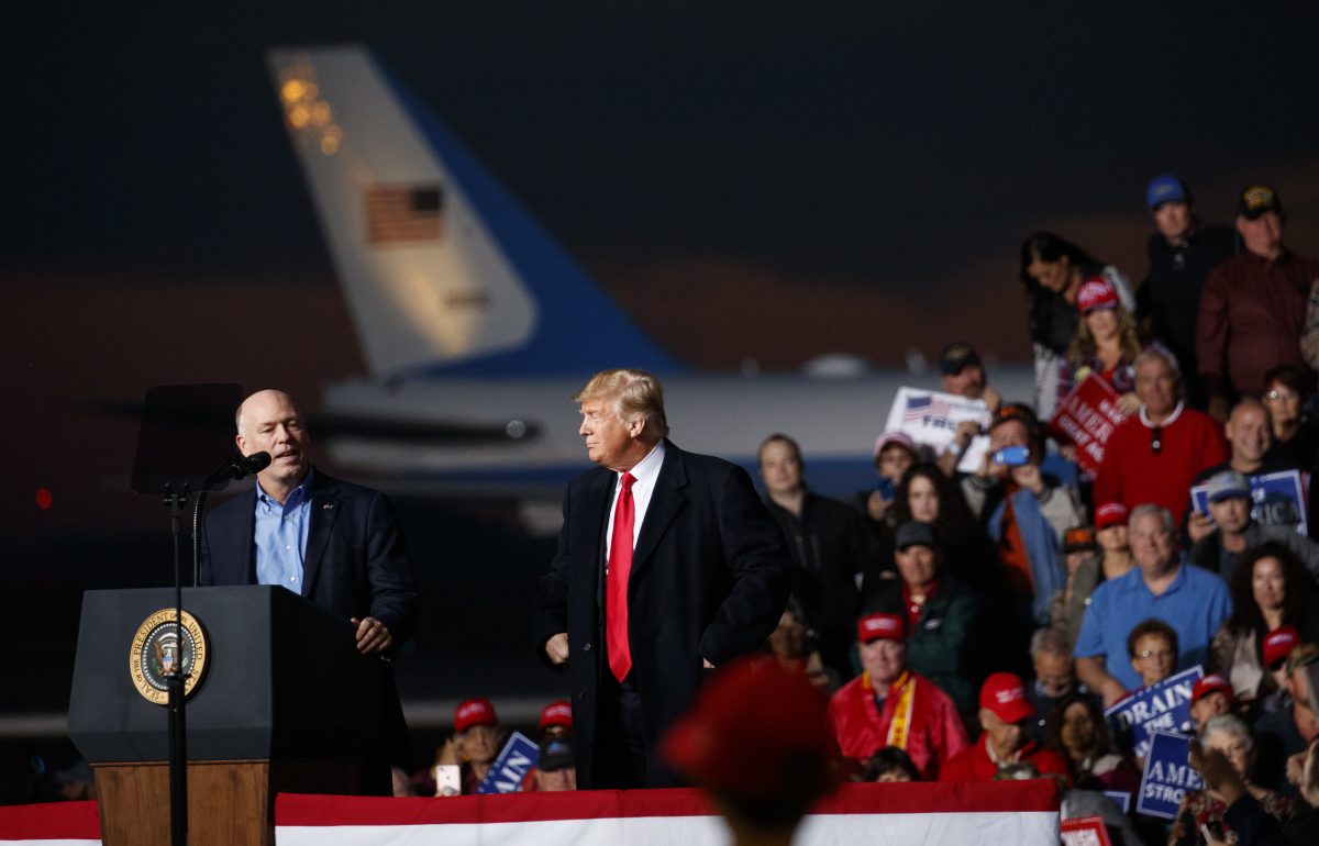 Rep. Greg Gianforte, R-Mont., speaks as President Donald Trump stands right during a campaign rally at Minuteman Aviation Hangar, Thursday, Oct. 18, 2018, in Missoula, Montana.