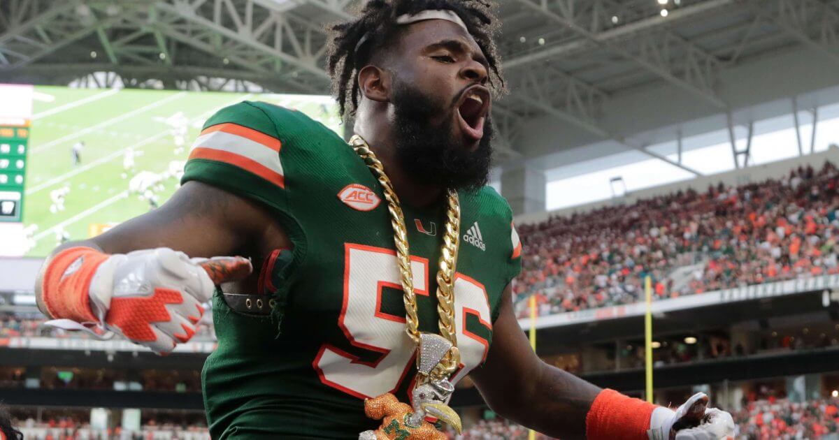 Miami linebacker Michael Pinckney celebrates with the turnover chain during the second half Saturday's game against Florida State. Miami won 28-27.