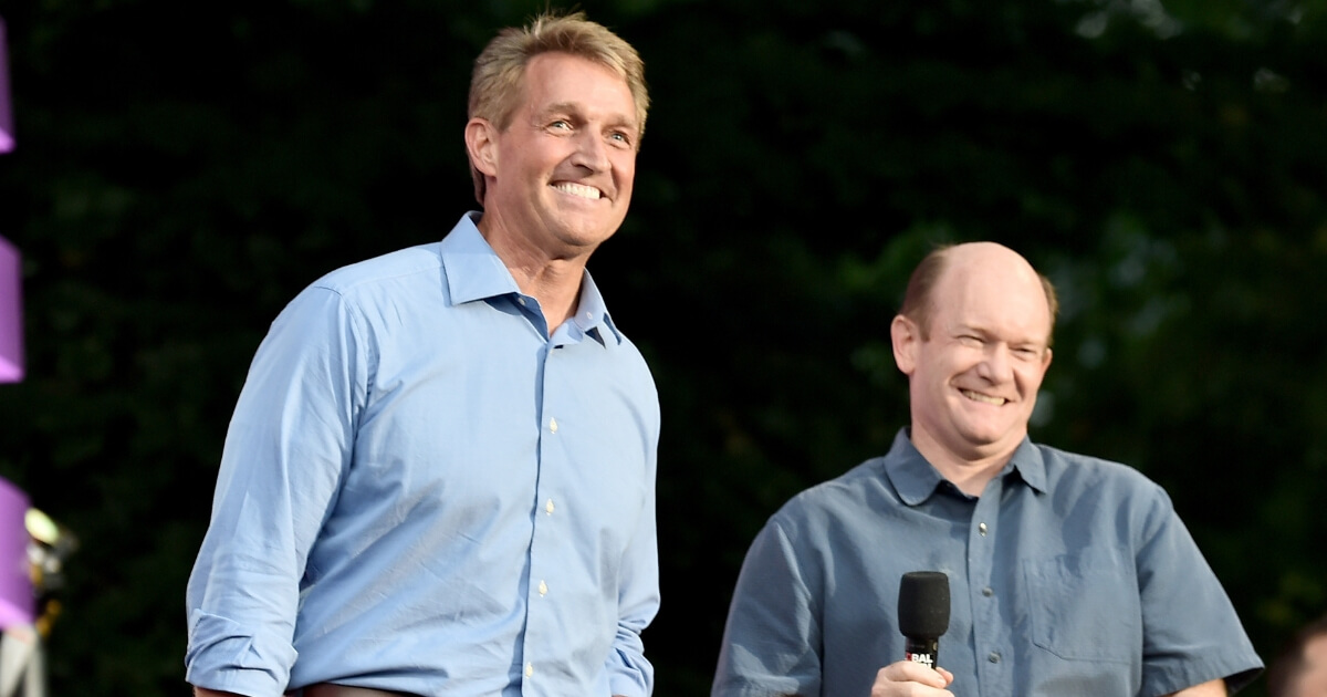 Jeff Flake and Chris Coons speak onstage during the 2018 Global Citizen Festival: