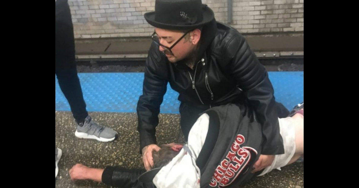 Man saves a fallen rider from the train tracks.