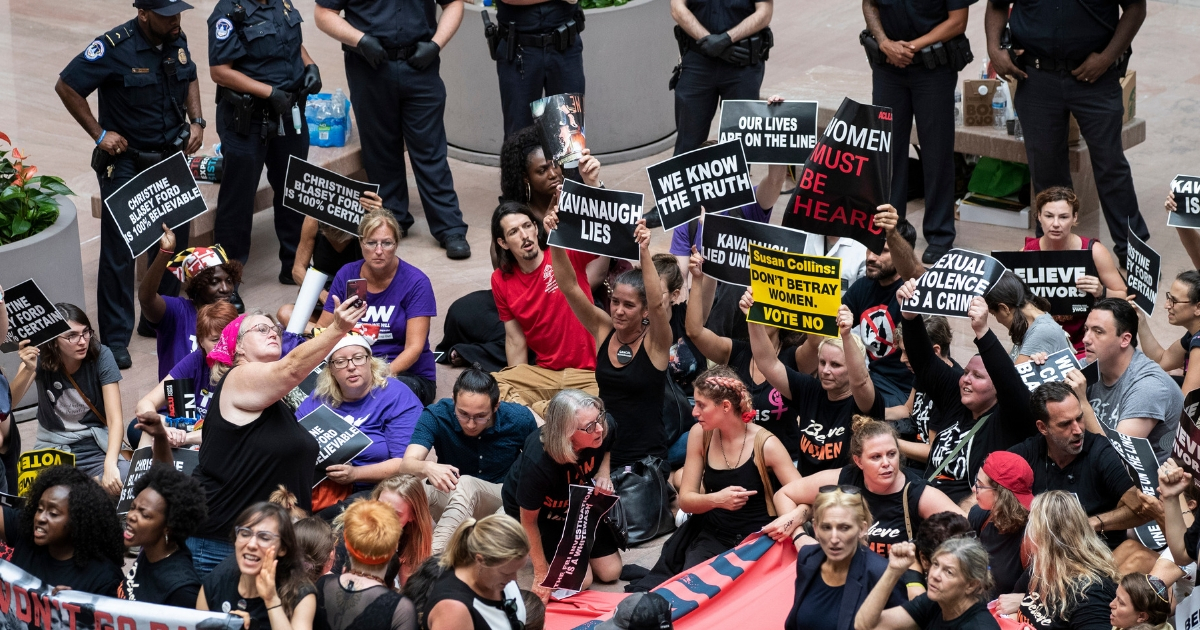 Protestors rally against Supreme Court nominee Judge Brett Kavanaugh in the atrium of the Hart Senate Office Building