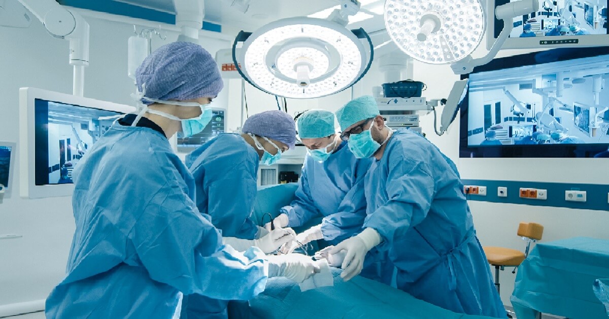A surgical team works in an operating room.